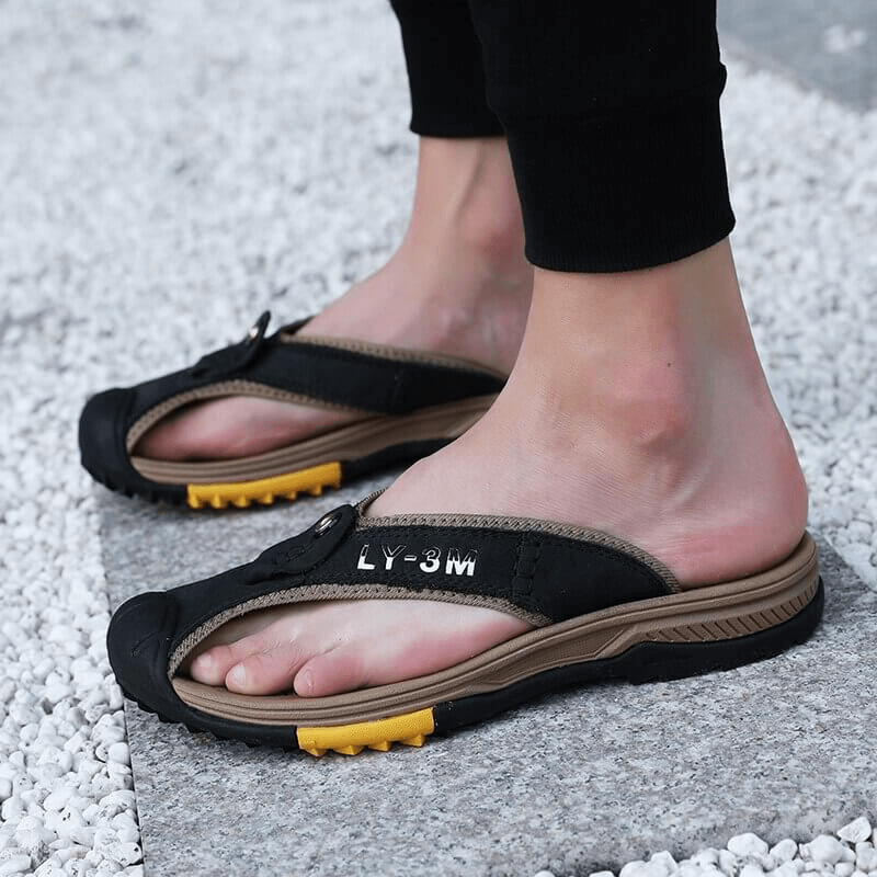 Casual men's genuine leather anti-slip flip flops, durable cow leather upper, rubber outsole for outdoor comfort, stylish solid black design.